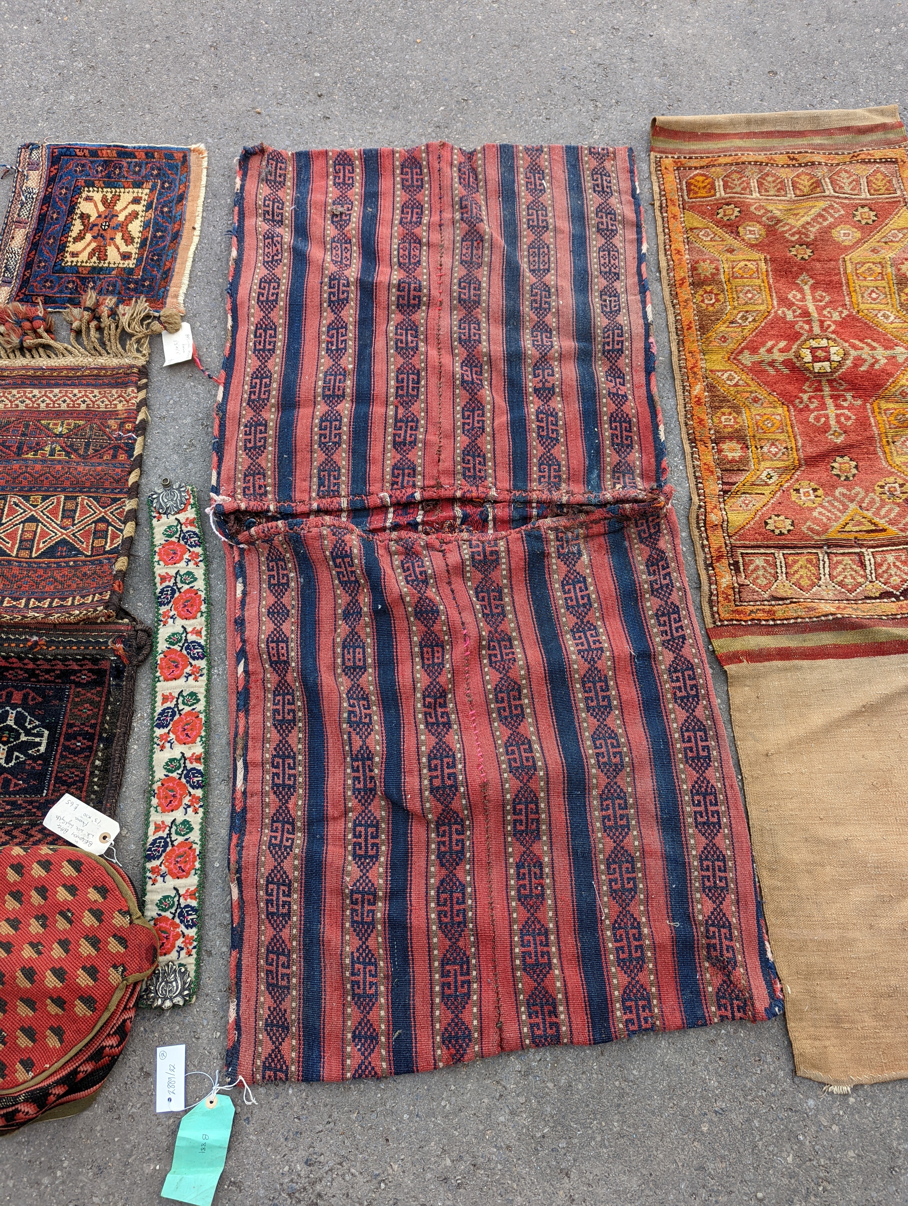 An Afghan Kilim flatweave saddlebag, 144 x 69cm together with six assorted bags, faces, etc.